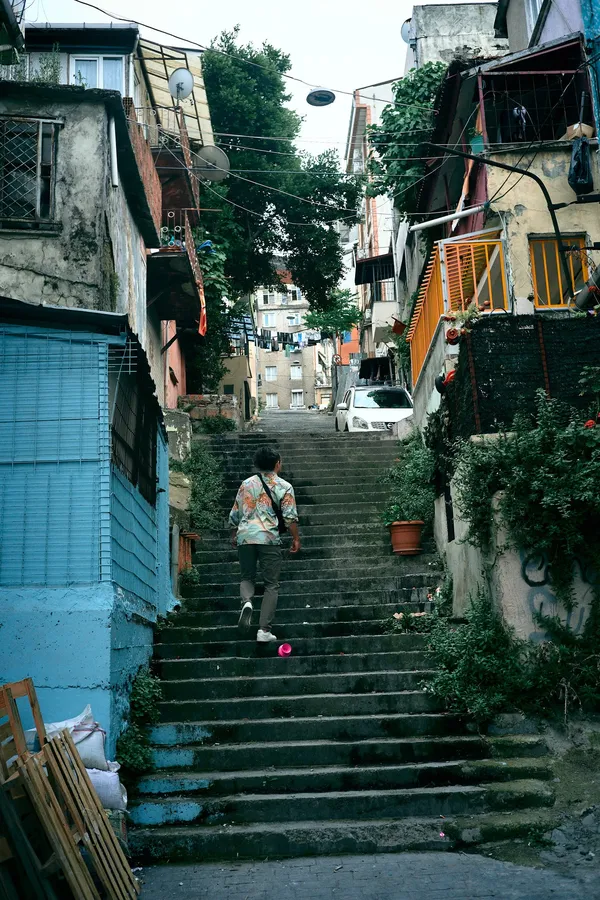Steep stepped alley between old houses and greenery, Istanbul, flash by Kilian Amrehn