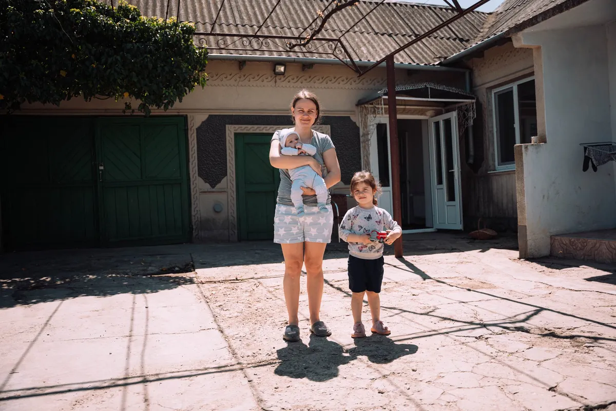 A mother with a baby in her arms and her child by the hand, Moldova 2022