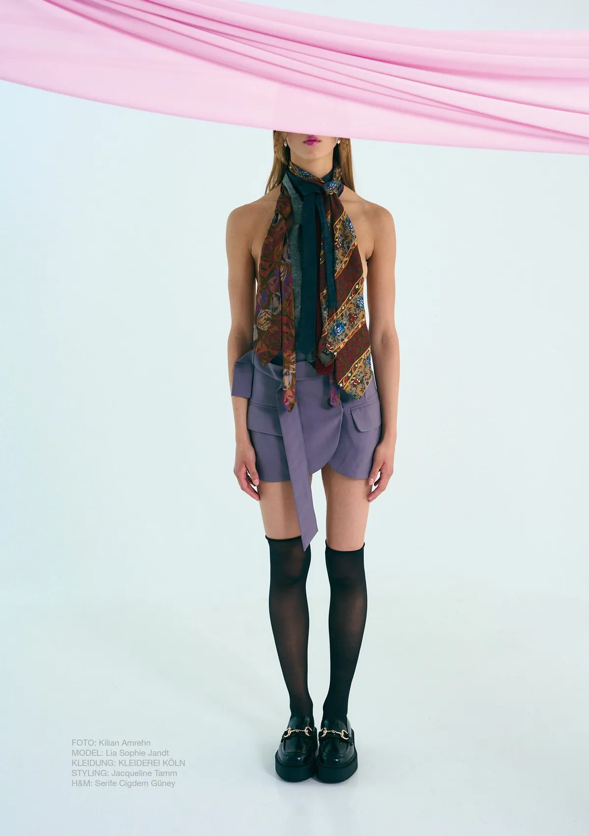 New Icons' Club Magazine, model wearing silk scarves as a top, lilac mini skirt and over-knee socks beneath a pink drape, editorial issue 1 2023, photographed by Kilian Amrehn