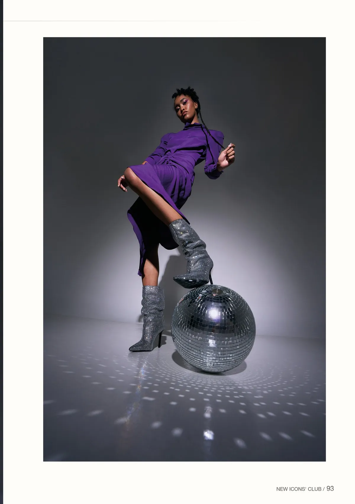 New Icons' Club Magazine, model in purple with silver boots resting a foot on a disco ball, light specks on the floor, editorial issue 1 2023, photographed by Kilian Amrehn