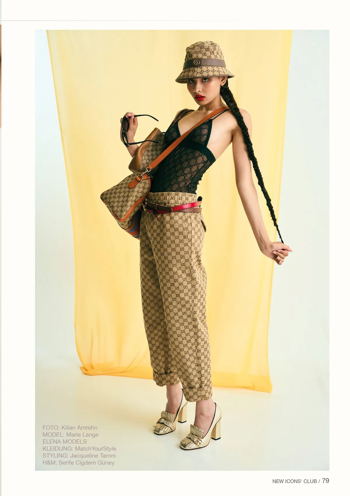 New Icons' Club Magazine, model with a long braid in monogram trousers, bucket hat and gold heels before yellow drape, magazine page, editorial issue 1 2023, photographed by Kilian Amrehn