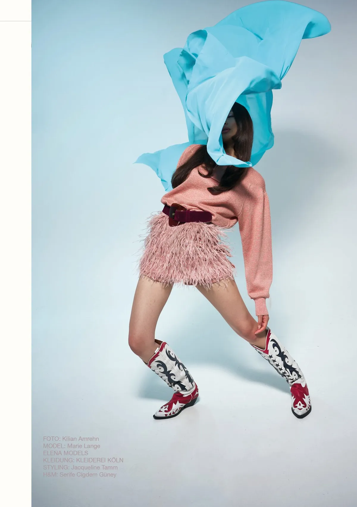 New Icons' Club Magazine, model with a turquoise fabric over her head, feather skirt and western boots against pale blue, editorial issue 1 2023, photographed by Kilian Amrehn