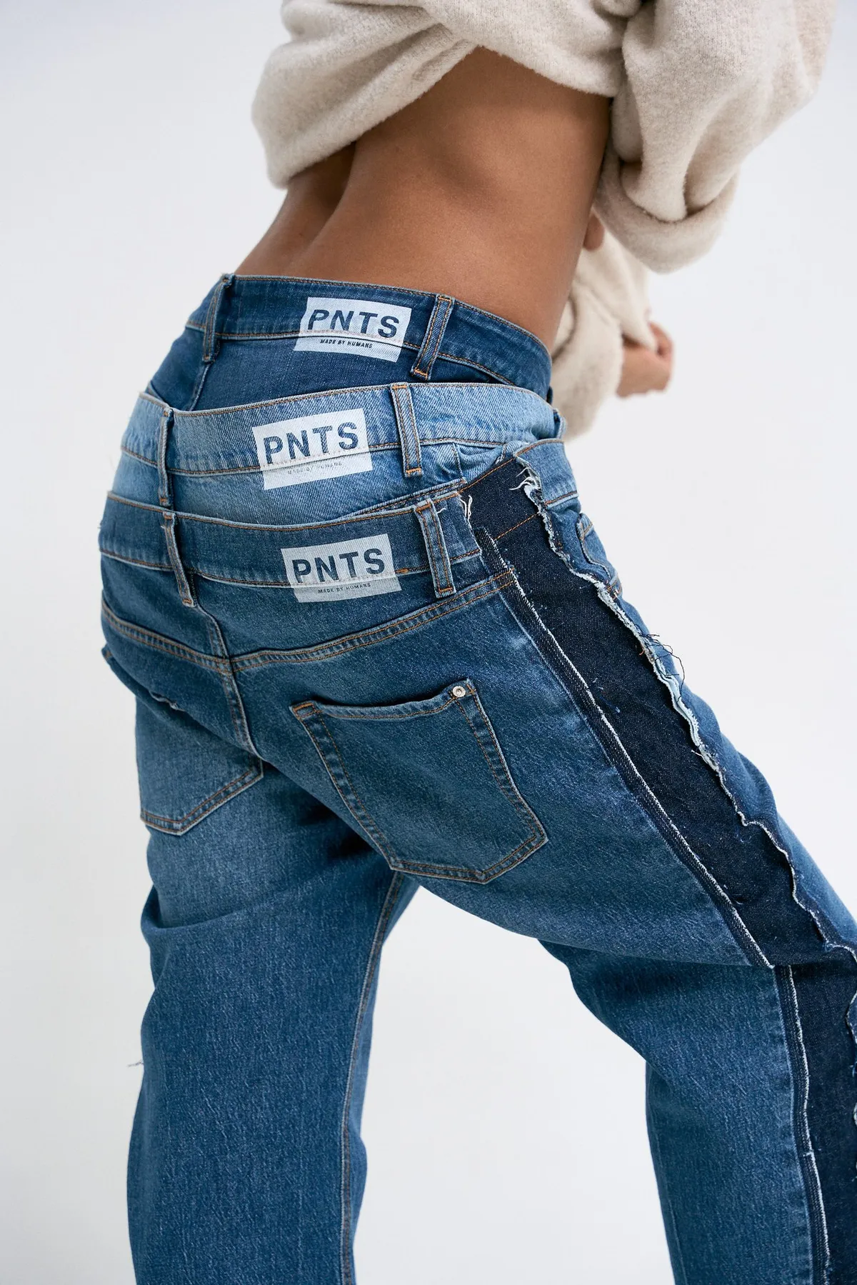 PNTS, rear view of two-tone jeans with stacked PNTS labels on the waistband, campaign 2022, photographed by Kilian Amrehn