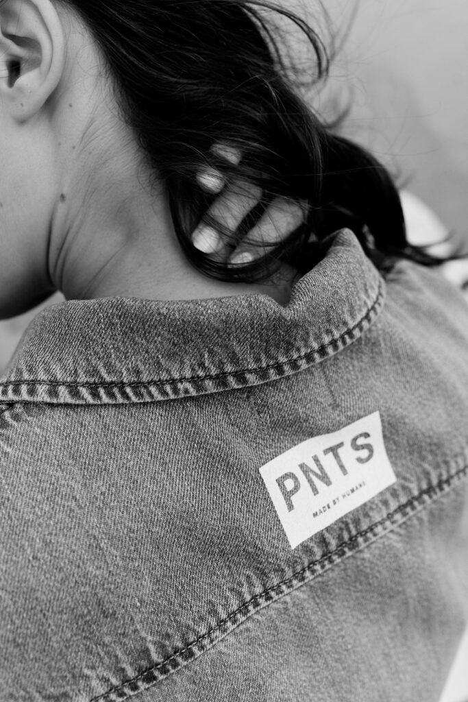 Schwarz-Weiß Fotoshooting von einem Model in Jeansjacke am Strand mit PNTS